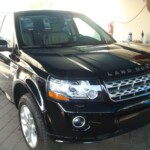 Before and after photographs of a damaged, black, Range Rover that was repaired by Elite Paint & Body Shop in West Palm Beach, FL.